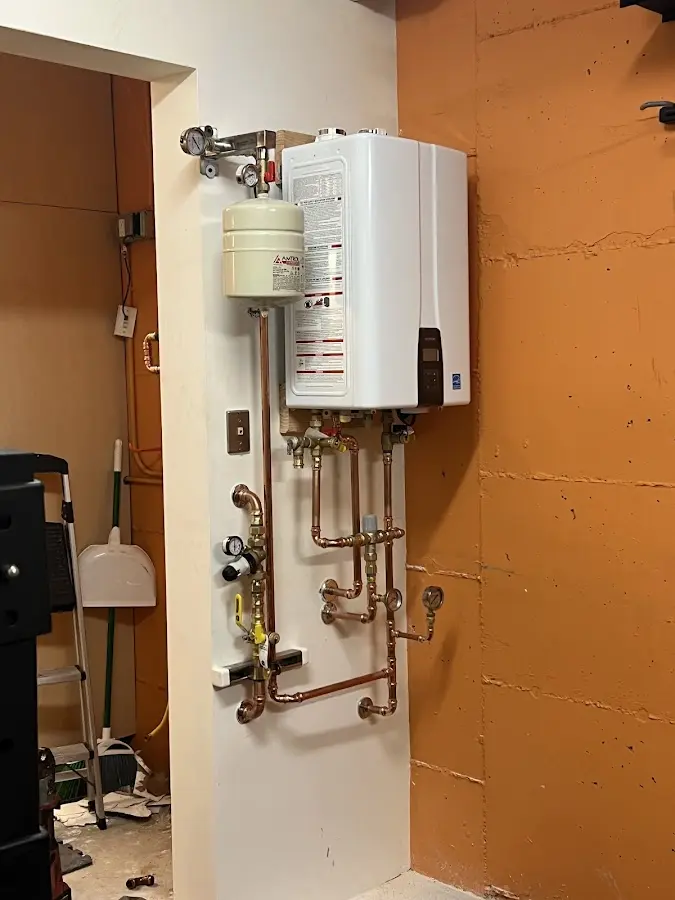 Plumbing technician inspecting water heater connections in Safety Harbor